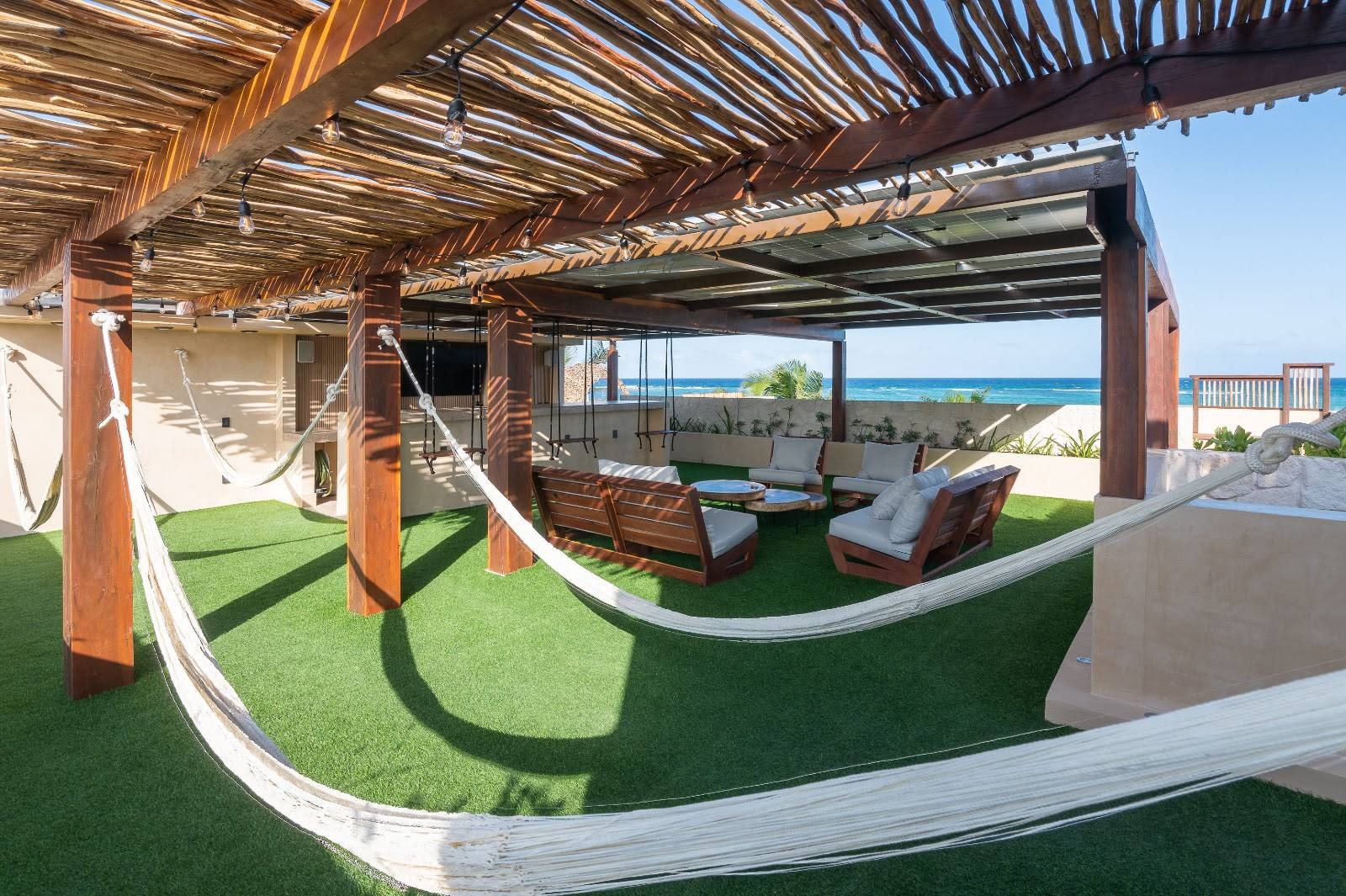 Hammocks and a lounge under the rooftop pergola