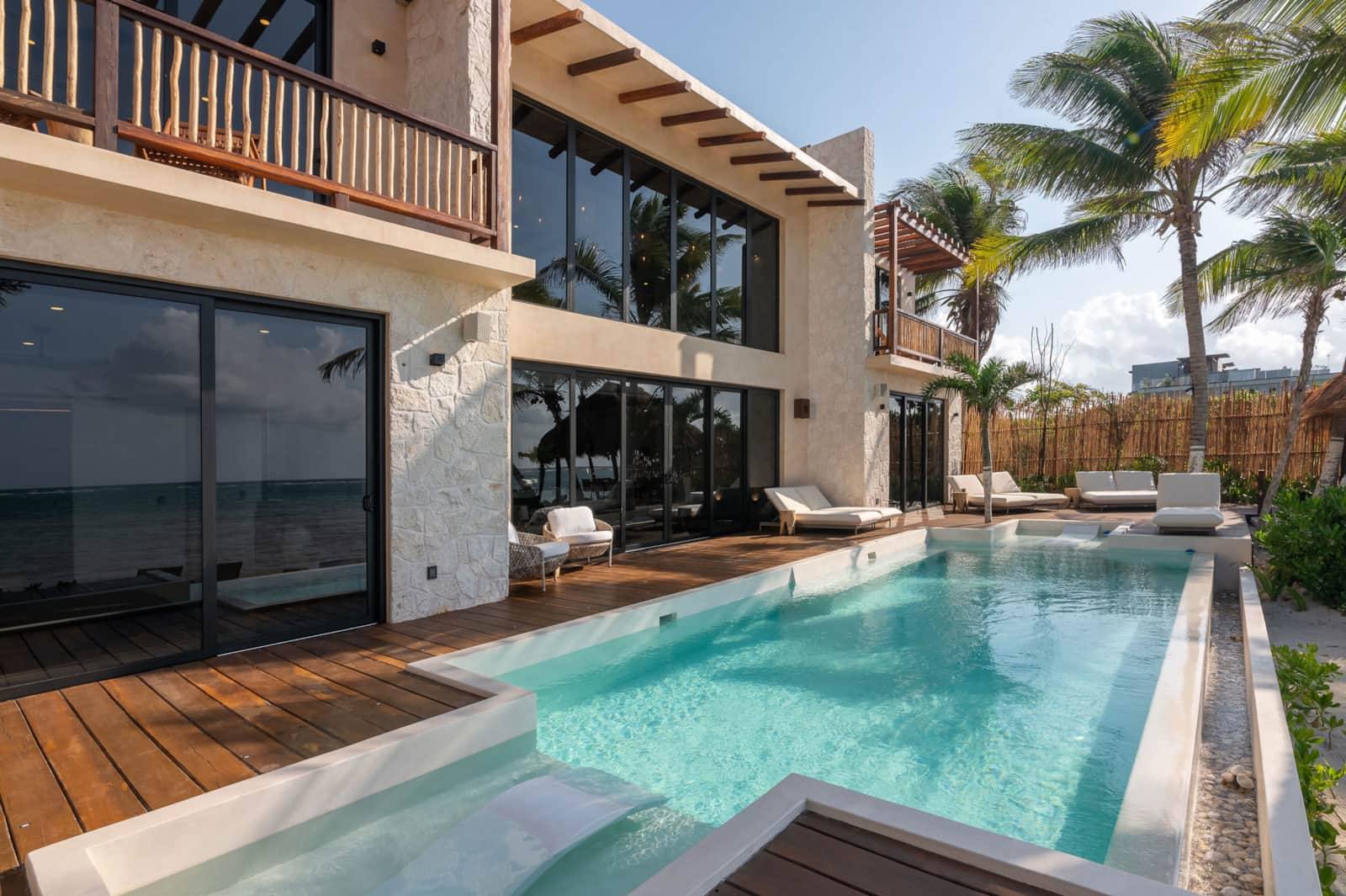 The pool and wooden deck beside the house