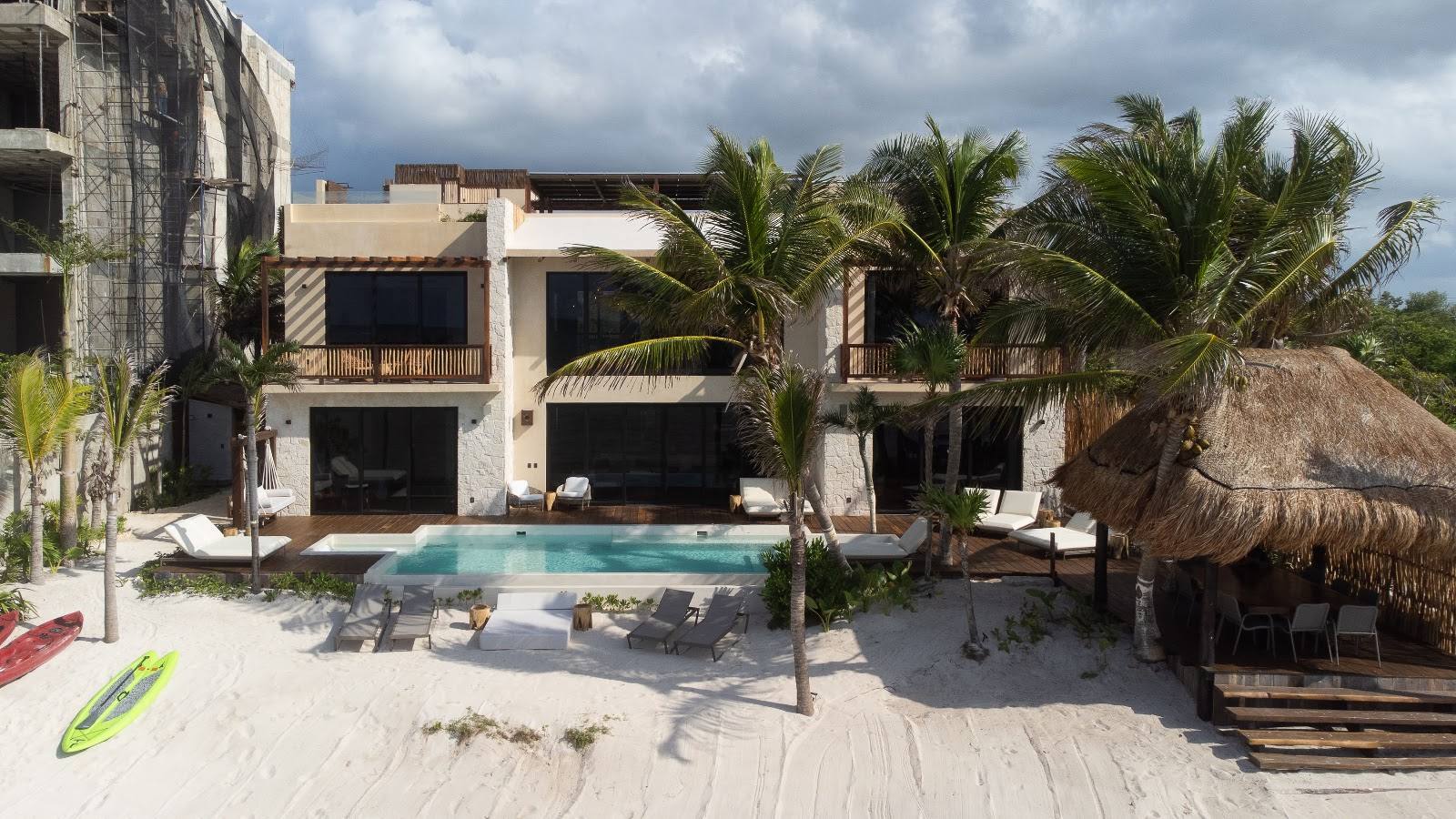 The house, pool and palms from the beach